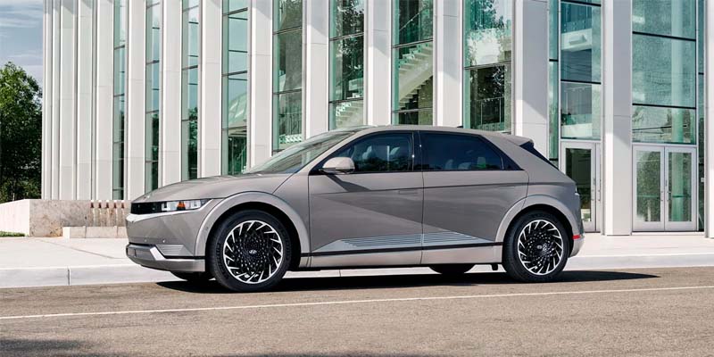Front view of Hyundai Ioniq parked beside a modern glass building