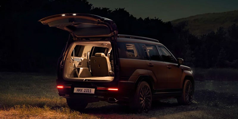 Rear view of Hyundai Santa Fe with open liftgate revealing interior at night