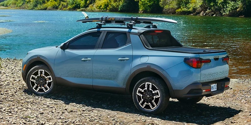 Hyundai Santa Cruz parked outdoors with a scenic lake view in the background.