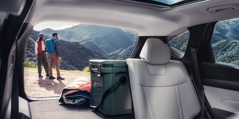 Hyundai Tucson cargo area with outdoor gear and mountain view